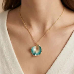 A close-up of a beautiful pendant necklace featuring a blue and gold design, worn on a person's neck.